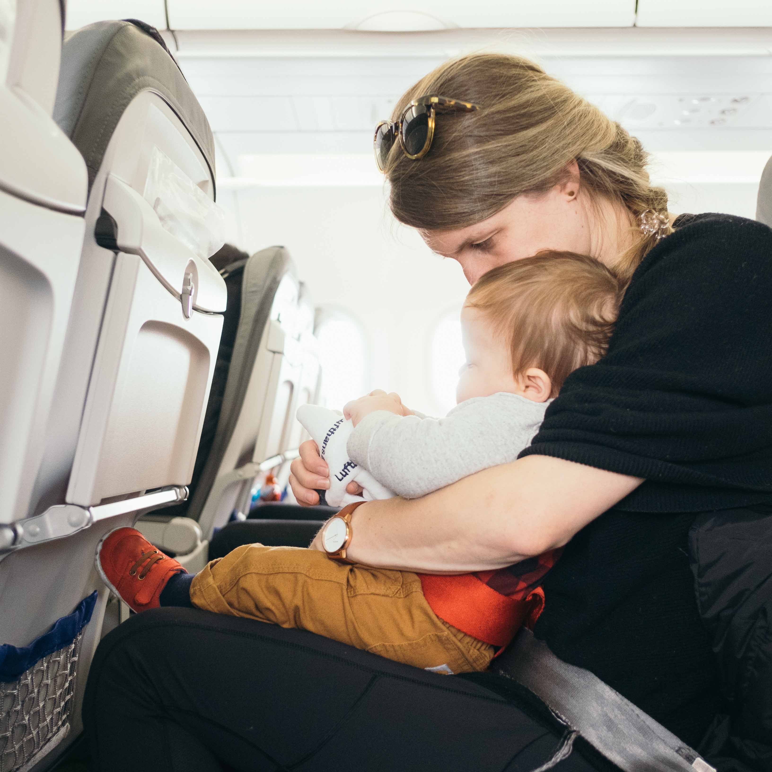 travelling with children: baby on a plane with mother